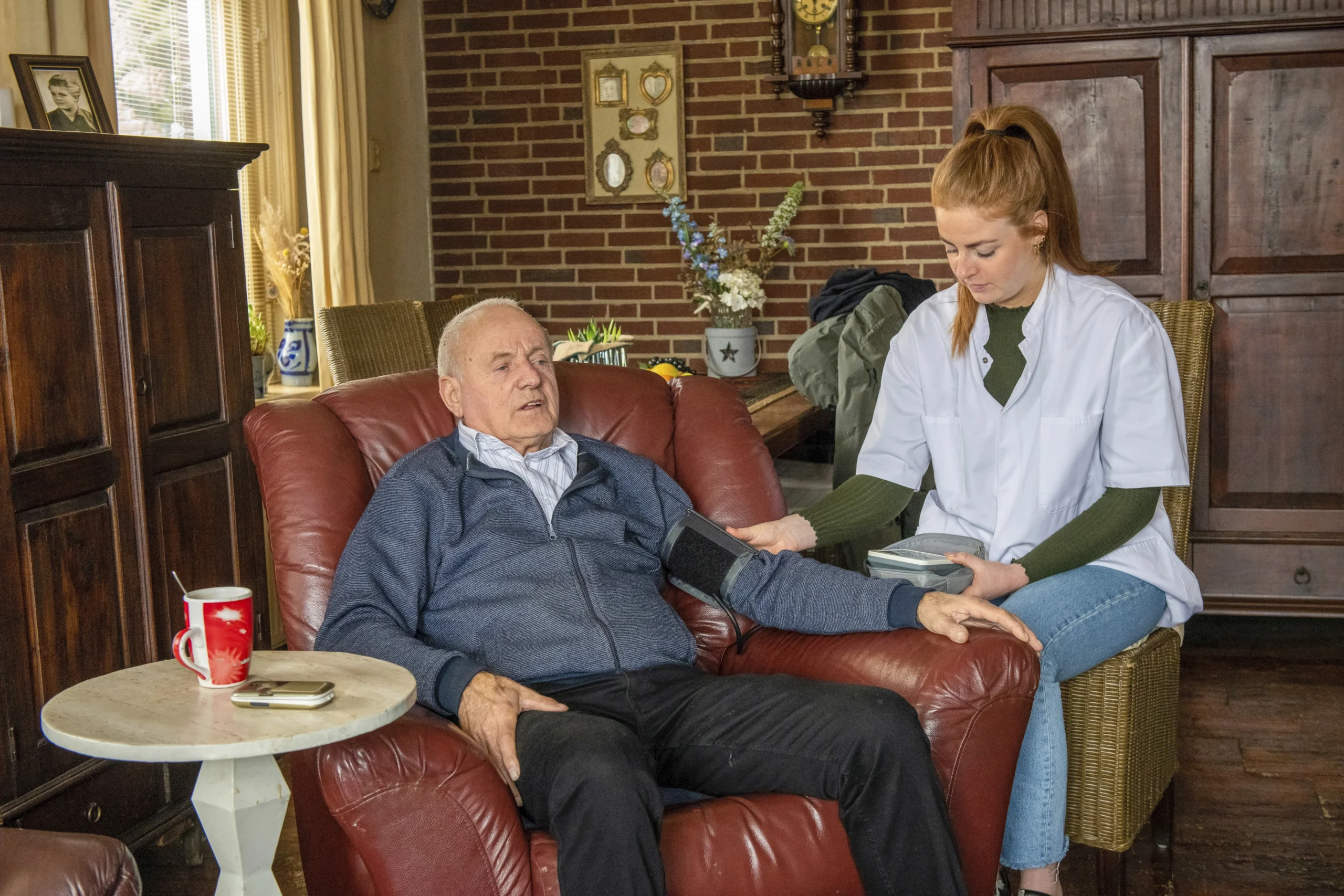 24-hour-home-care-in-Rush-City-MN-2 care nurse checks blood pressure of elderly male in recliner