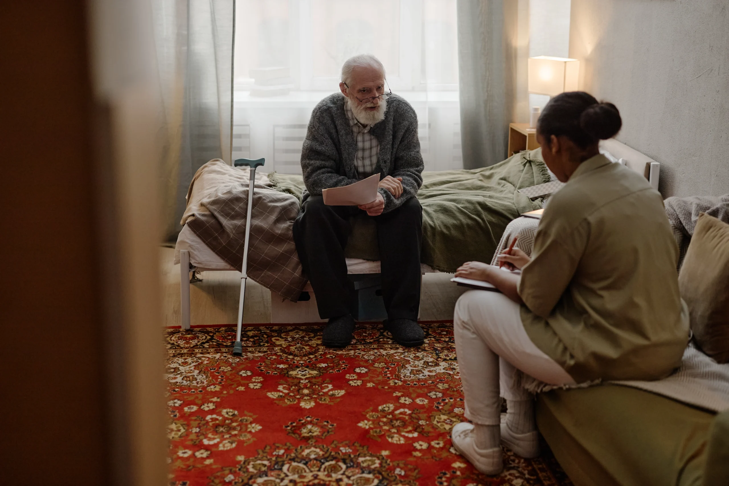 Veterans-Home-Care-in-Minneapolis-MN-2 elerly veteran does paperwork with young female caregiver
