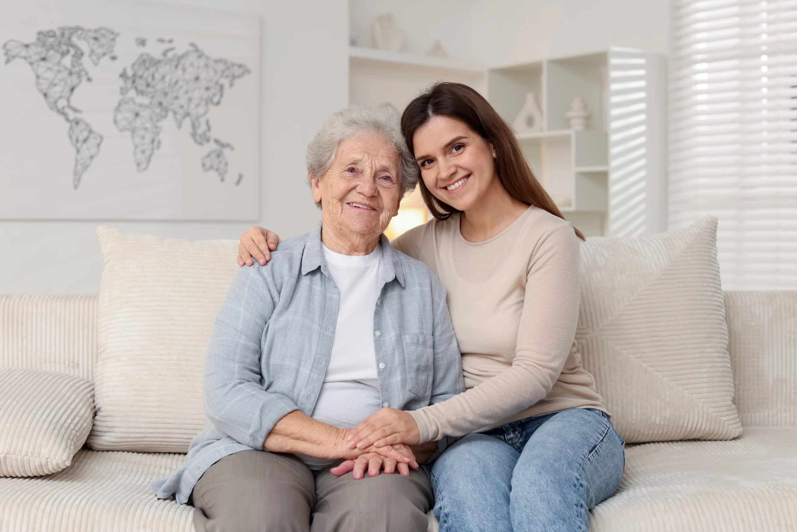 elder-home-care-in-Minneapolis-MN-2 senior woman smiling on couch with brunettte caregiver