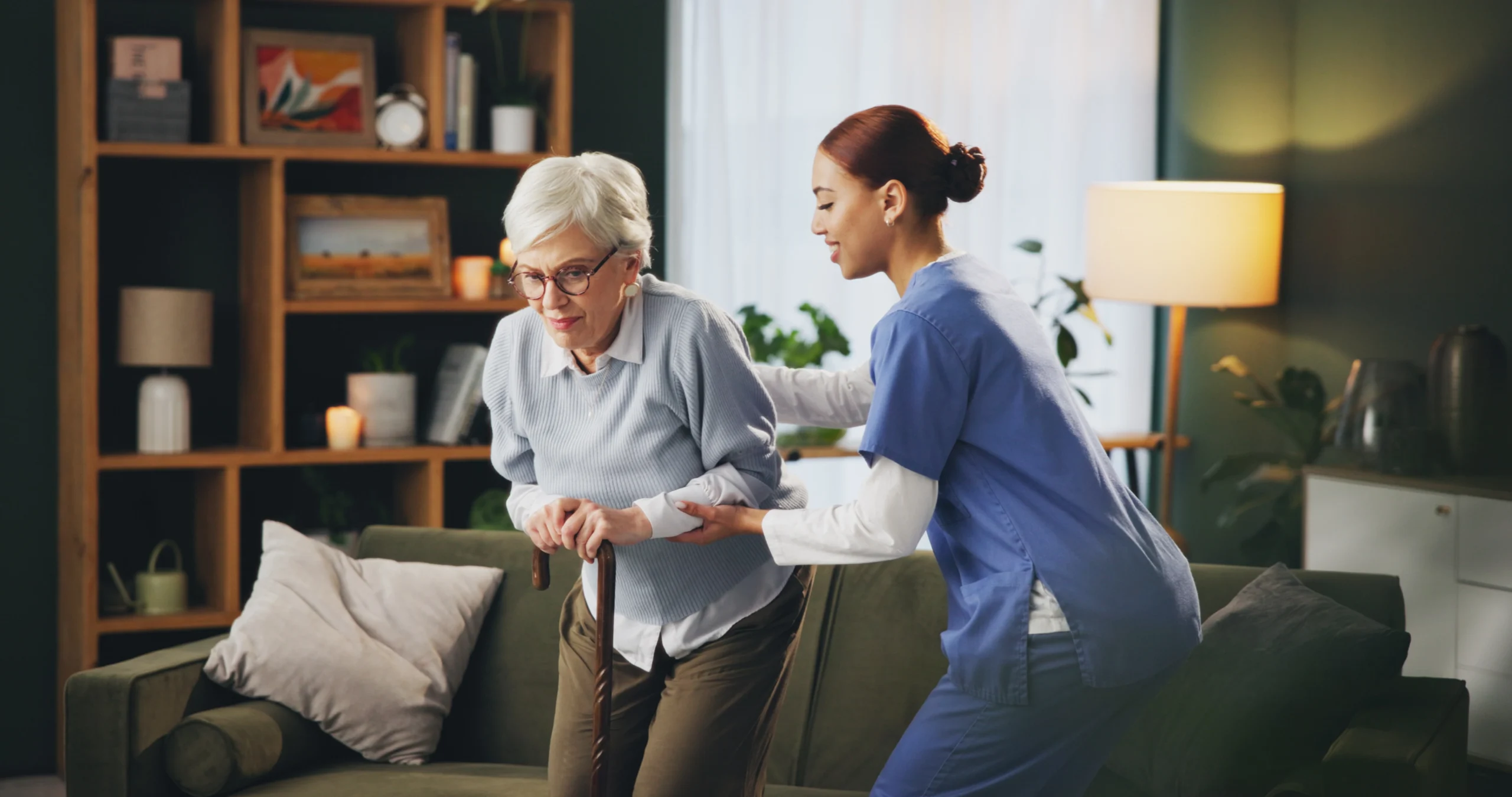 skilled-nursing-home-care-in-Rush-City-MN-2 caregiver assisting woman with cane on couch
