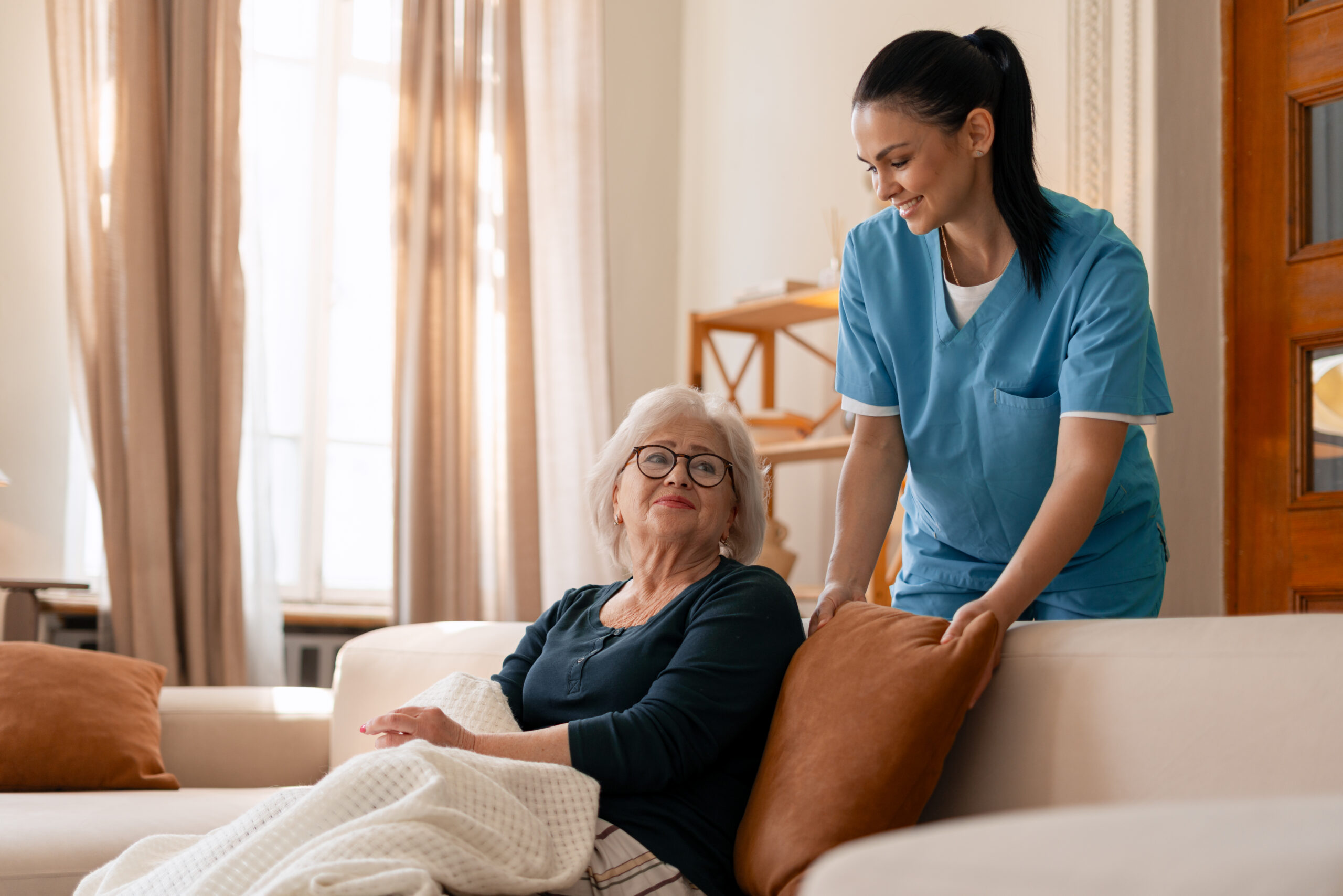 Professional caregiver assessing elderly care needs in Andover, MN, through a personalized in-home elder care evaluation, reviewing daily living activities, mobility, memory support, and safety to create a customized care plan that helps seniors remain independent at home.